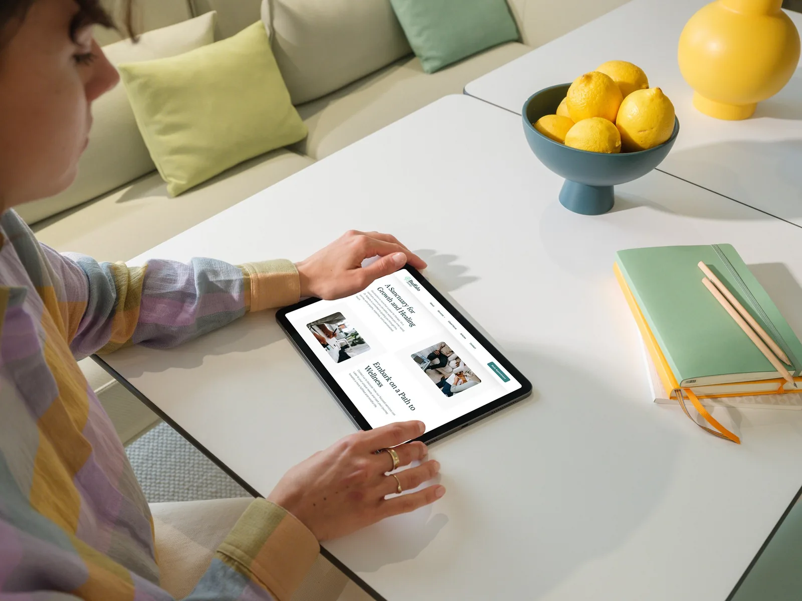 Person viewing a clean website design on a tablet, showcasing responsive layout.