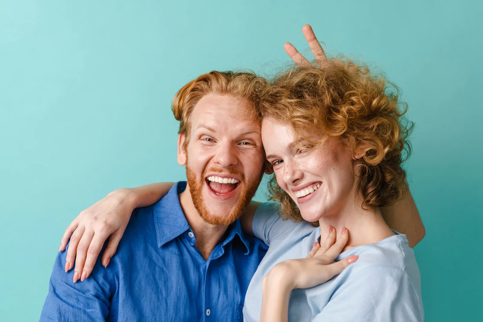 Happy man and woman smiling, reflecting our friendly website design.