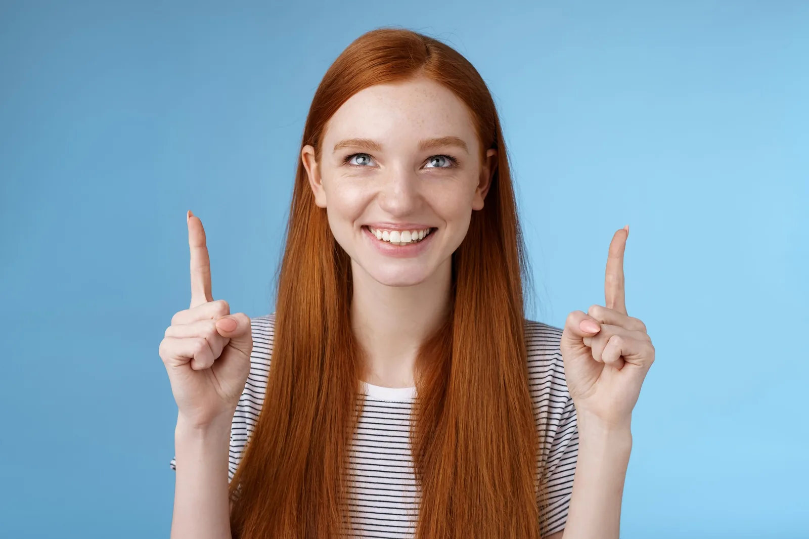 Smiling woman points up, indicating growth for SEO services the region.