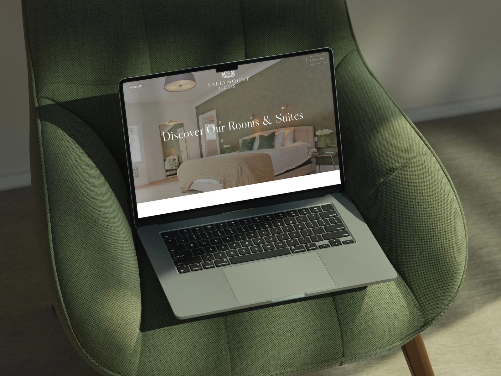 website design displaying hotel rooms and booking CTA on a laptop.