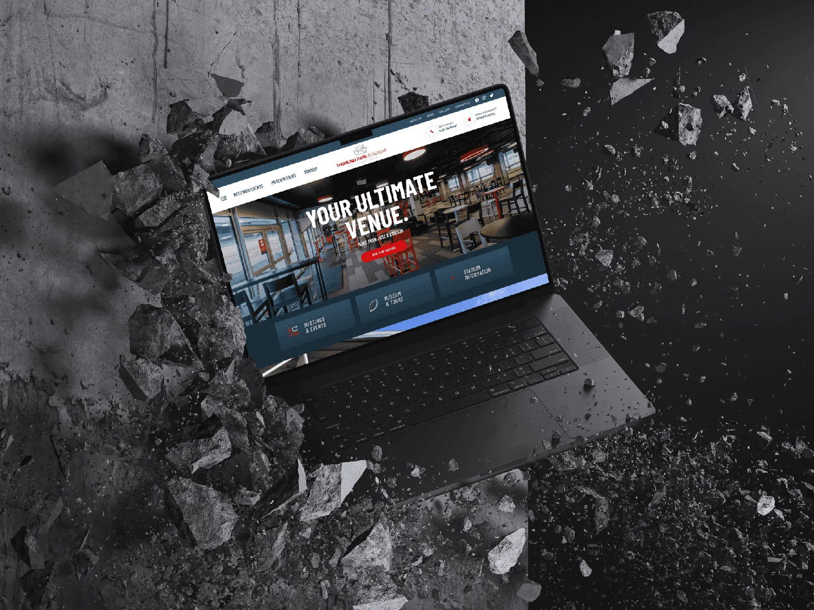 Website on laptop breaking concrete, showcasing website design.